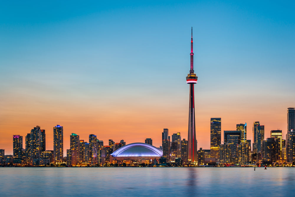 Skyline of Toronto over Ontario Lake at twilight.